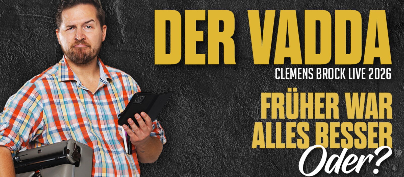 Clemens Brock mit einem Handy in der Hand auf einem dunklem Hintergrund