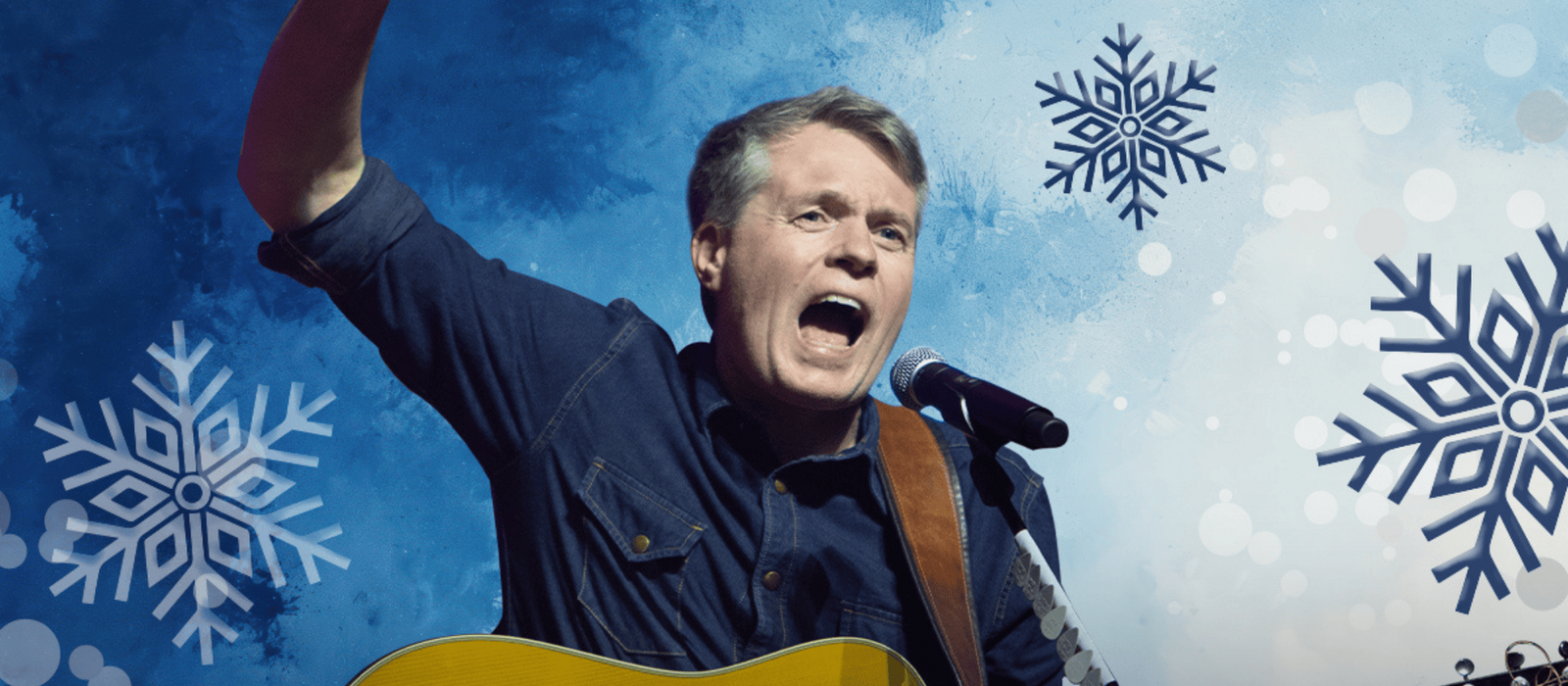 Jimmy Kelly vor einem winterlichen Hintergrund mit gezeichneten Eisblumen, mit einer Gitarre singend.